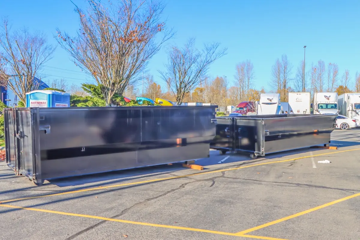 Professional dumpster rental service with roll-off container on residential driveway in Pecan Grove